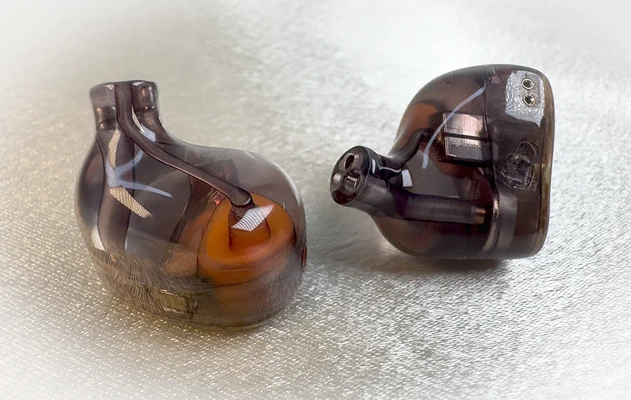 Tansio Mirai TSMR Armor in-ear monitors shown with their gold faceplates and transparent shells