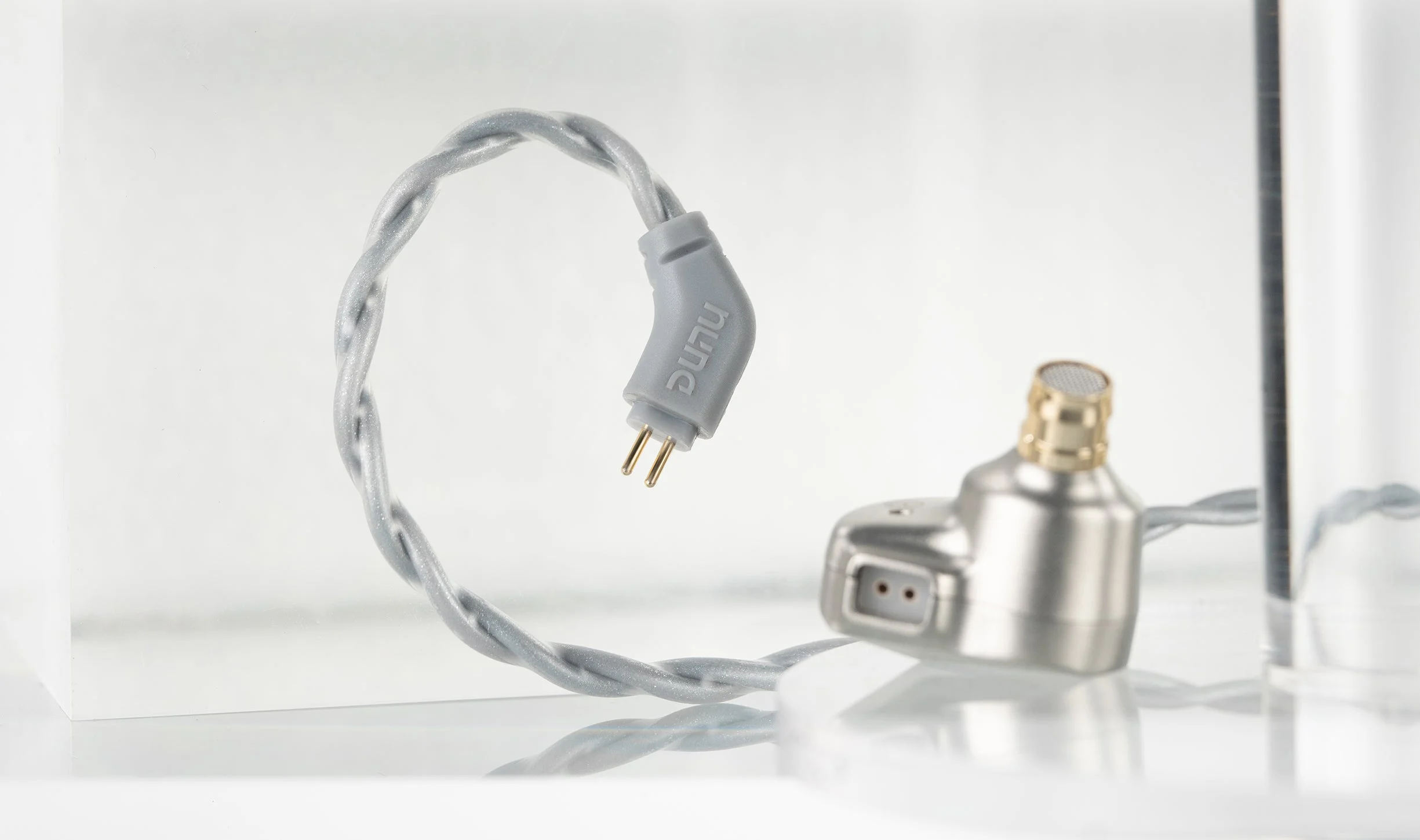 DUNU Kima 2 in-ear monitors product image showing the stainless steel shells and cable